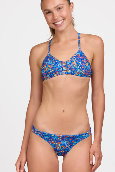 Female model wearing the Women's Europe Bikini Bottom in the Calendula print, standing in front of a grey background shown from the front view 

|| Size S, Hip 36.5"
