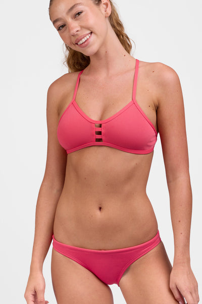 Male model wearing the Women's Europe Bikini Bottom in the Guava Crush solid, standing in front of a grey background, shown from the front view

|| Size S, Hip 34"  
