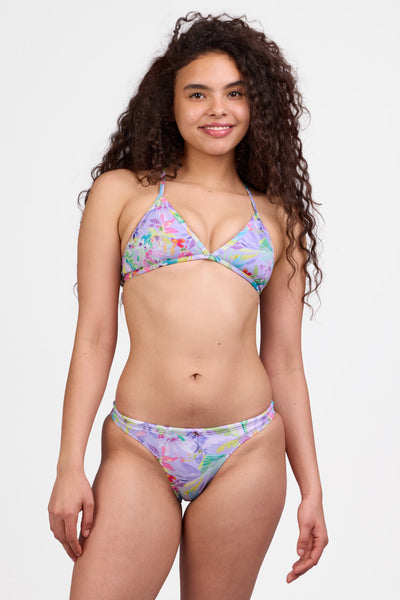 Female model wearing the Women's Europe Bikini Bottom in the Surreal Magic print, standing in front of a grey background shown from the front view

|| Size S, Hips 34"