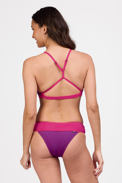 Female model wearing the Women's Softy Bikini Bottom in the Fig contrast, standing in front of a grey background shown from the back view

|| Size S, Hips 36 1/2"  
