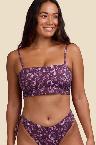 Female model wearing the Women's Alessia Bikini Top in the Bondi Blossom print, standing in front of a yellow background shown from the front view

|| Size S, Bust 34"  