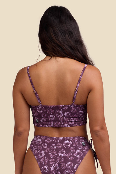 Female model wearing the Women's Alessia Bikini Top in the Bondi Blossom print, standing in front of a yellow background shown from the back view

|| Size S, Bust 34"  