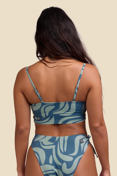 Female model wearing the Women's Alessia Bikini Top in the Sumatra print, standing in front of a yellow background shown from the back view

|| Size S, Bust 34"  