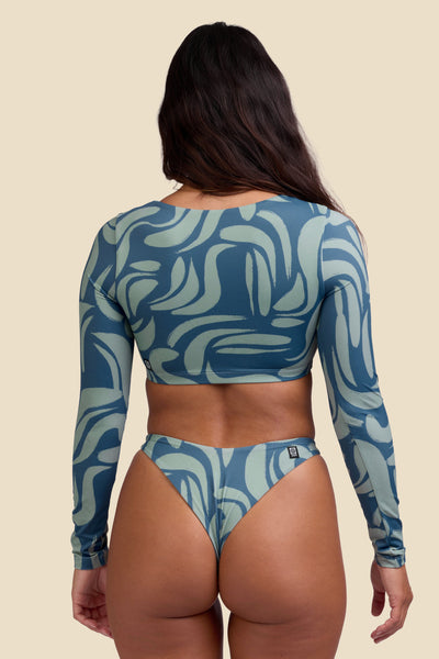 Female model wearing the Women's Avalon Bikini Top in the Sumatra print, standing in front of a yellow background shown from the back view

|| Size S, Bust 34"  