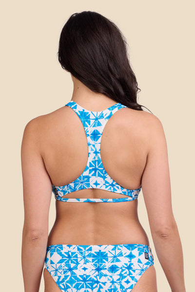 Female model wearing the Women's Doris Bikini Top in the Bluefin print, standing in front of a yellow background shown from the back view

|| Size M, Bust 32"  
