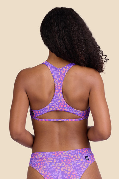 Female model wearing the Women's Doris Bikini Top in the Jellybean print, standing in front of a yellow background shown from the back view

|| Size S, Bust 32"