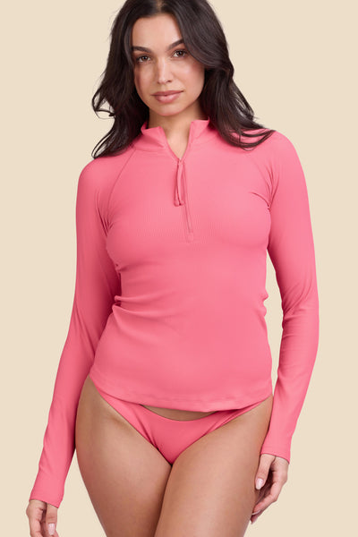 Female model wearing the Women's Erica Zip Rashguard in the Tea Rose Ribbed solid, standing in front of a yellow background shown from the front view

|| Size M, Bust 32"  