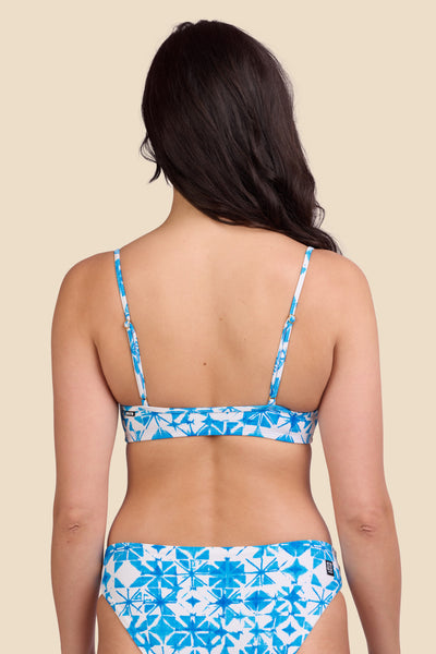 Female model wearing the Women's Eryn Bikini Top in the Bluefin print, standing in front of a yellow background shown from the back view

|| Size M, Bust 32"  
