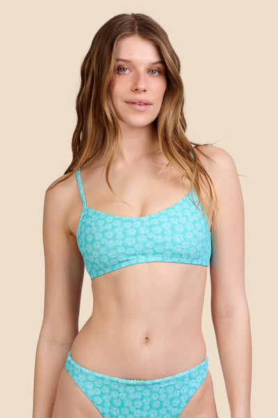 Female model wearing the Women's Eryn Bikini Top in the Clamshell Ribbed print, standing in front of a yellow background shown from the front view

|| Size S, Bust 30.5"  
