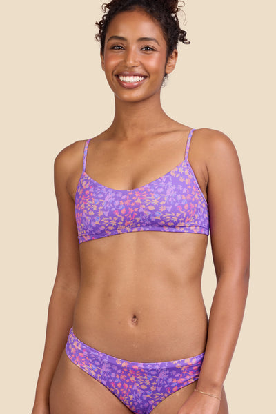 Female model wearing the Women's Eryn Bikini Top in the Jellybean print, standing in front of a yellow background shown from the front view

|| Size S, Bust 32"