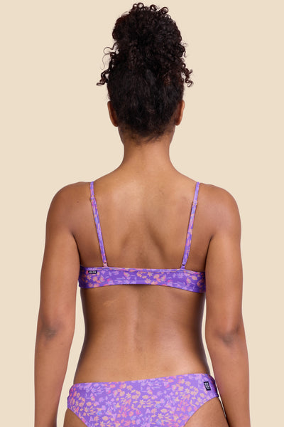 Female model wearing the Women's Eryn Bikini Top in the Jellybean print, standing in front of a yellow background shown from the back view

|| Size S, Bust 32"