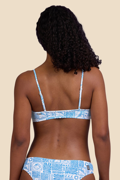 Female model wearing the Women's in the Eryn Bikini Top in the Swell print, standing in front of a yellow background shown from the back view

|| Size S, Bust 32"