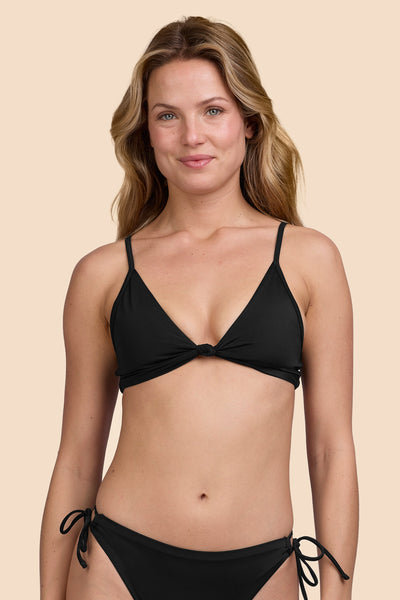 Female model wearing the Womens Faye Bikini Top in the Black solid, standing in front of a yellow background shown from the front view

|| Size S, Bust 33"  
