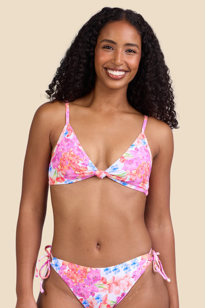 Female model wearing the Women's Faye Bikini Top in the Orchids ribbed print, standing in front of a yellow background shown from the front view

|| Size S, Bust 32" 