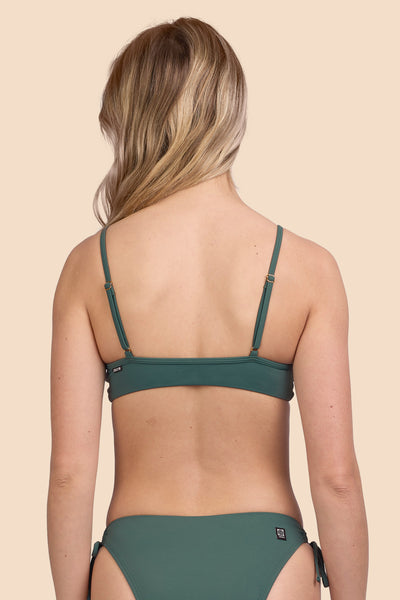 Female model wearing the Womens Faye Bikini Top in the Zucchini solid, standing in front of a yellow background shown from the back view

|| Size M, Bust 33"  