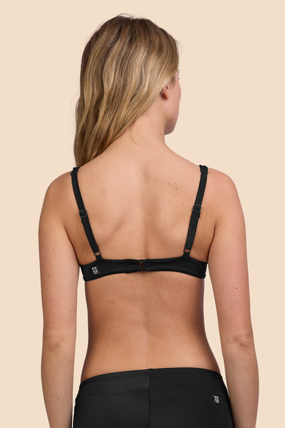 Female model wearing the Womens Hadley Bikini Top in the Black solid, standing in front of a yellow background shown from the back view

|| Size S, Bust 33"  