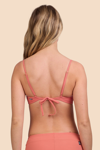 Female model wearing the Women's Hikari Bikini Top in the Serrano Ribbed solid, standing in front of a yellow background, shown from the back view

|| Size S, Bust 33" 