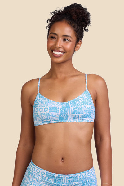 Female model wearing the Women's in the Hikari Bikini Top in the Swell print, standing in front of a yellow background shown from the front view

|| Size S, Bust 32"