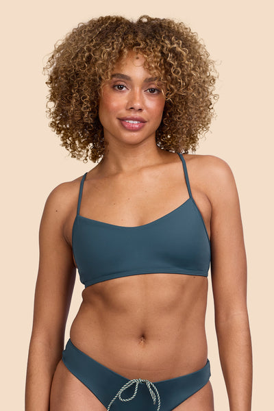Female model wearing the Women's Hikari Bikini Top the Underwater solid, standing in front of a yellow background shown from the front view

|| Size S, Bust 32.5"  