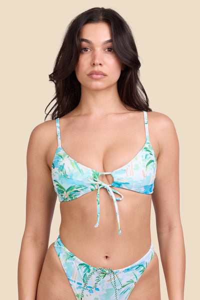 Female model wearing the Women's Jenny Bikini Top in the Cocopalm print, standing in front of a yellow background shown from the front view

|| Size M, Bust 32"  
