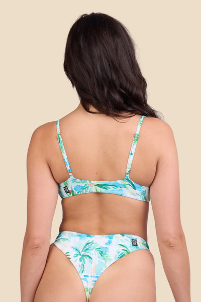 Female model wearing the Women's Jenny Bikini Top in the Cocopalm print, standing in front of a yellow background shown from the back view

|| Size M, Bust 32"  

