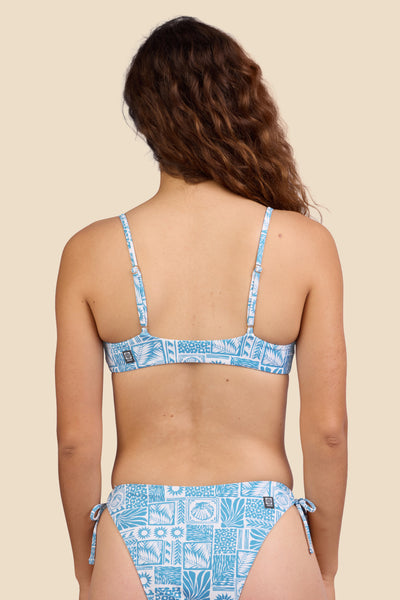 Female model wearing the Women's in the Jenny Bikini Top in the Swell print, standing in front of a yellow background shown from the back view

|| Size S, Bust 35.5"