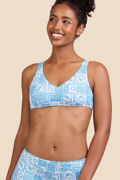 Female model wearing the Women's in the Kacey Bikini Top in the Swell print, standing in front of a yellow background shown from the front view

|| Size S, Bust 32"