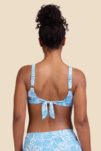 Female model wearing the Women's in the Kacey Bikini Top in the Swell print, standing in front of a yellow background shown from the back view

|| Size S, Bust 32"