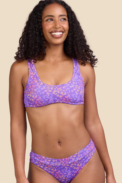 Female model wearing the Women's Larisa Bikini Top in the Jellybean print, standing in front of a yellow background shown from the front view

|| Size S, Bust 32"