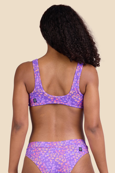 Female model wearing the Women's Larisa Bikini Top in the Jellybean print, standing in front of a yellow background shown from the back view

|| Size S, Bust 32"