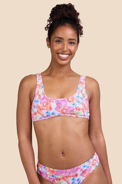 Female model wearing the Women's Larisa Bikini Top in the Orchids ribbed print, standing in front of a yellow background shown from the front view

|| Size S, Bust 32" 