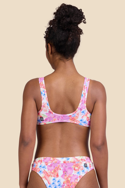 Female model wearing the Women's Larisa Bikini Top in the Orchids ribbed print, standing in front of a yellow background shown from the back view

|| Size S, Bust 32" 