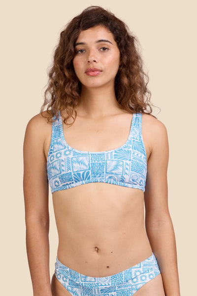 Female model wearing the Women's in the Larisa Bikini Top in the Swell print, standing in front of a yellow background shown from the front view

|| Size S, Bust 35.5"