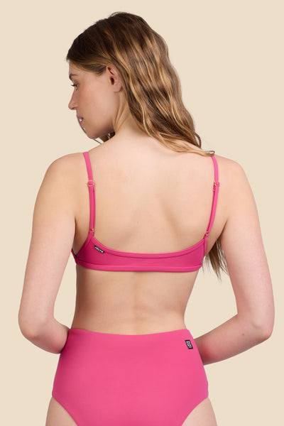 Female model wearing the Women's Lori Bikini Top in the Berry solid, standing in front of a yellow background shown from the back view

|| Size S, Bust 30.5"  
