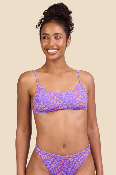 Female model wearing the Women's Lori Bikini Top in the Jellybean print, standing in front of a yellow background shown from the front view

|| Size S, Bust 32"