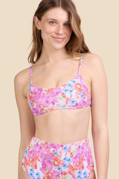 Female model wearing the Women's Lori Bikini Top in the Orchids ribbed print, standing in front of a yellow background shown from the front view

|| Size S, Bust 30.5" 