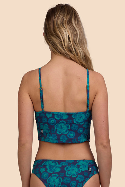 Female model wearing the Women's Luca Tankini Top in the Moon Flower, standing in front of a yellow background, shown from the back view

|| Size S, Bust 33"