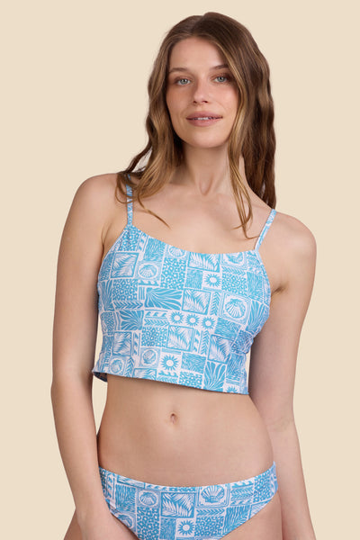 Female model wearing the Women's in the Luca Tankini Top in the Swell print, standing in front of a yellow background shown from the front view

|| Size S, Bust 30.5"