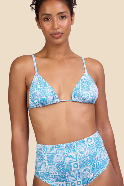 Female model wearing the Women's in the Margie Bikini Top in the Swell print, standing in front of a yellow background shown from the front view

|| Size S, Bust 32"