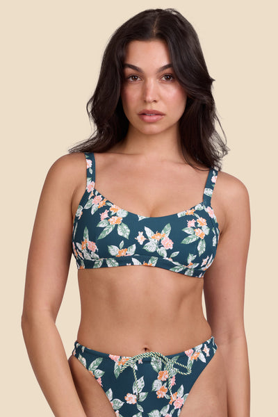 Female model wearing the Women's Nellie Bikini Top in the Islander Ribbed print, standing in front of a yellow background shown from the front view

|| Size M, Bust 32"  