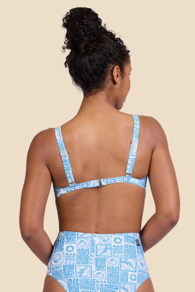 Female model wearing the Women's in the Nellie Bikini Top in the Swell print, standing in front of a yellow background shown from the back view


|| Size S, Bust 32"