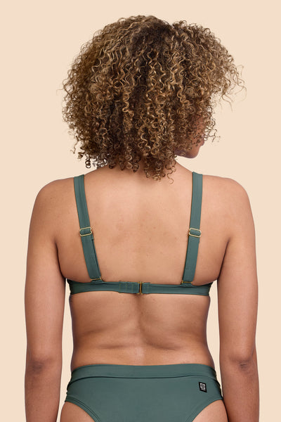 Female model wearing the Women's Nellie Bikini Top in the Zucchini solid, standing in front of a yellow background shown from the back view

|| Size S, Bust 32.5"  
