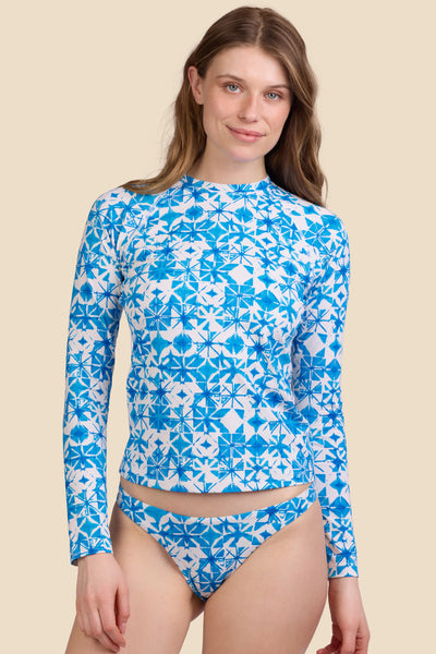 Female model wearing the Women's Noonan Rashie in the Bluefin print, standing in front of a yellow background shown from the front view

|| Size S, Bust 30.5"  

