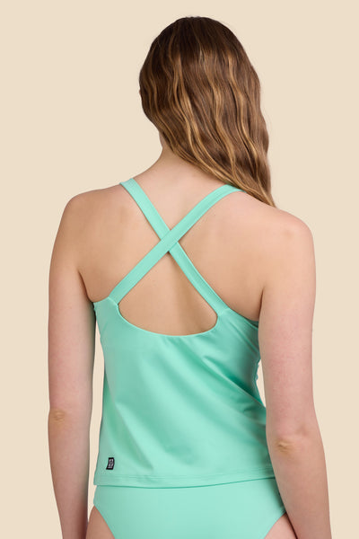 Female model wearing the Women's Paula Tankini Top in the Mint Tulip solid, standing in front of a yellow background shown from the back view

|| Size S, Bust 30.5"  
