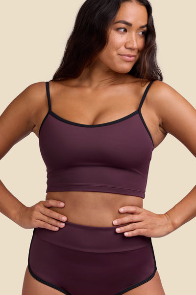 Female model wearing the Women's Wren Bikini Top in the Sangria solid, standing in front of a yellow background shown from the front view

|| Size S, Bust 34"  