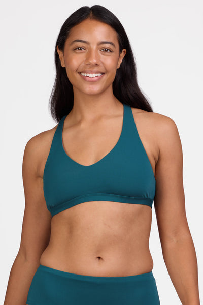 Female model wearing the Women's Eloise    D+ Bikini Top in the Peacock solid, standing in front of a grey background shown from the front view


|| Size L, Bust 36"
