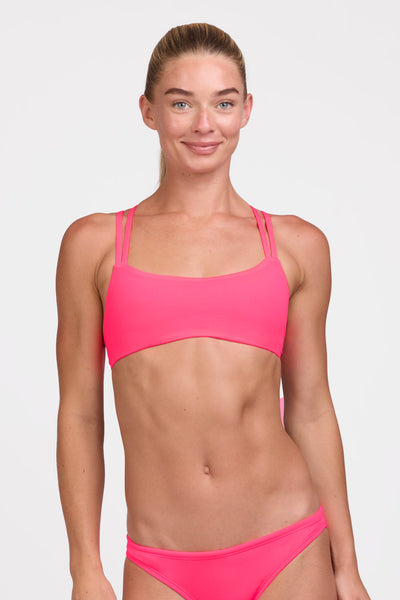 Female model wearing the Women's Fendrick Bikini Top in the Hot Pink solid, standing in front of a grey background shown from the front view

|| Size S, Bust 33"