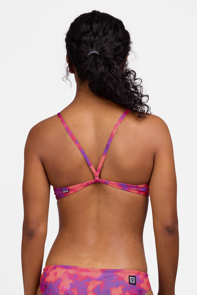 Female model wearing the Women's Jocelyn Bikini Top in the Canvas print, standing in front of a grey background shown from the back view

|| Size S, Bust 32.5"  