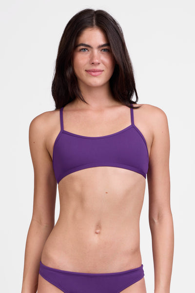 Female model wearing the Women's Jocelyn Bikini Top in the Grape solid, standing in front of a grey background shown from the front view

|| Size S, Bust 31"