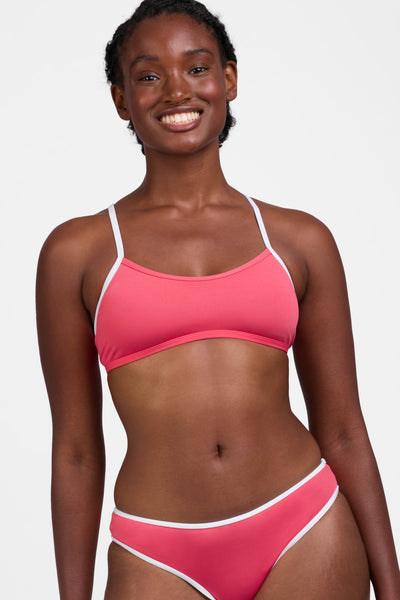 Male model wearing the Women's Jocelyn Bikini Top in the Guava Crush contrast, standing in front of a grey background, shown from the front view

|| Size M, Bust 34"  